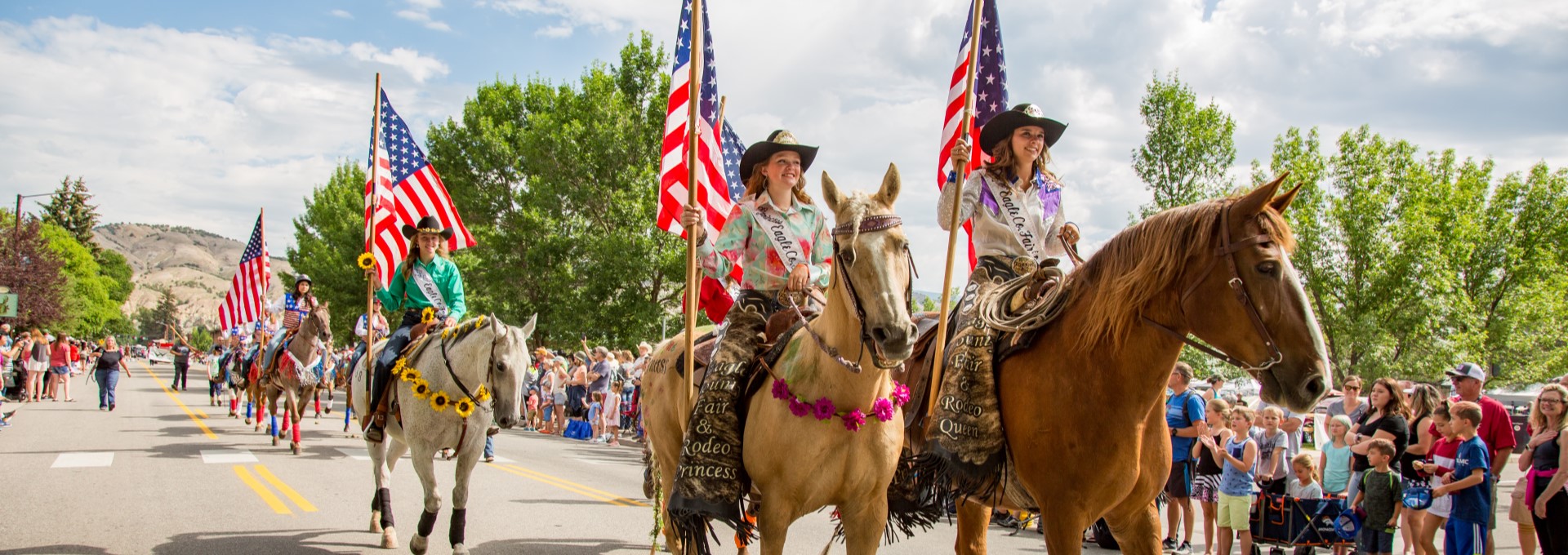 Gypsum parade people riding horses carrying the American flag